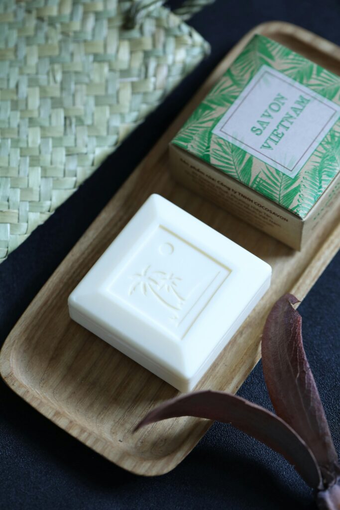 Organic bar soap displayed elegantly on a wooden tray with tropical design box.